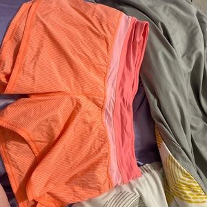 These shorts are striped with light pink and coral.